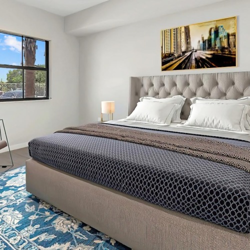 a bedroom with a bed and a chair