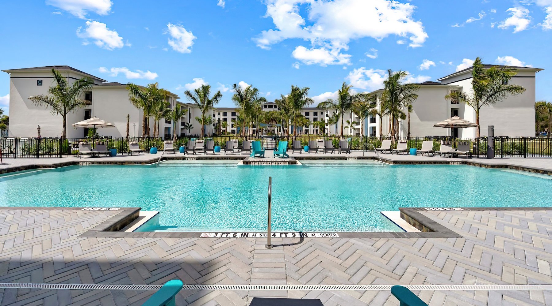 a pool with chairs around it
