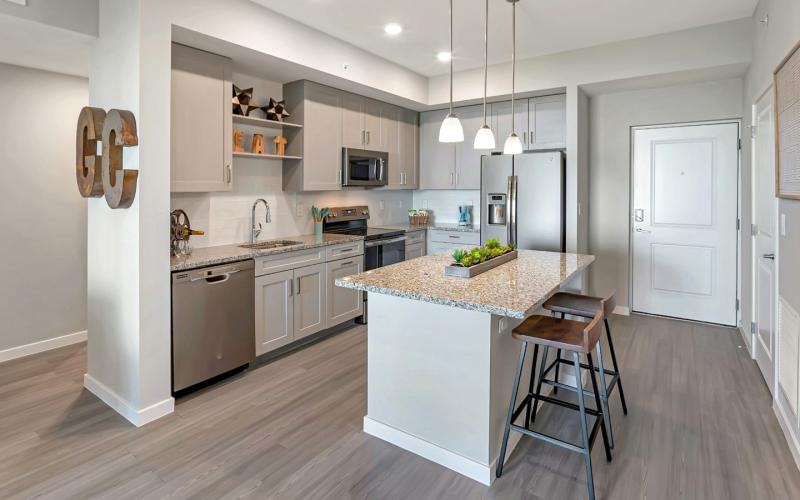 a kitchen with a bar stool and a table