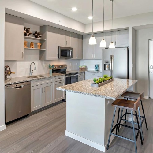a kitchen with an island and a bar stool