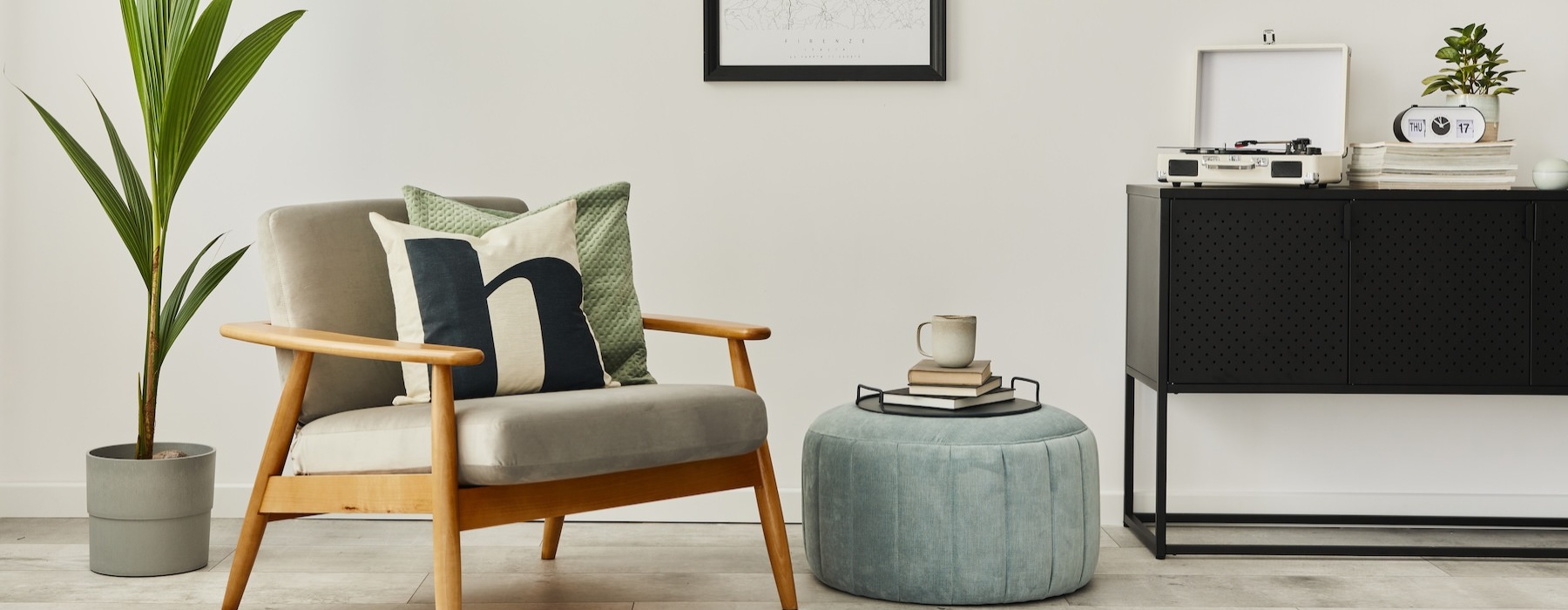 a room with a chair, table and plant